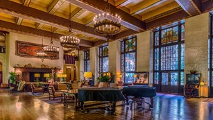 hotel lobby with seating and chandeliers