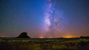 the milky way over a desert landscape