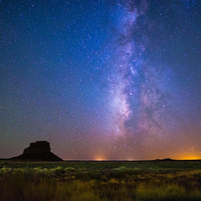 the milky way over a desert landscape