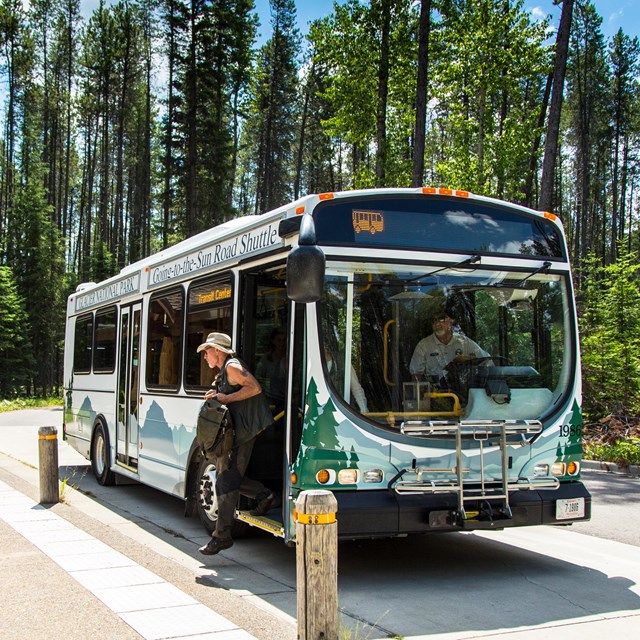 people disembark a bus that says 