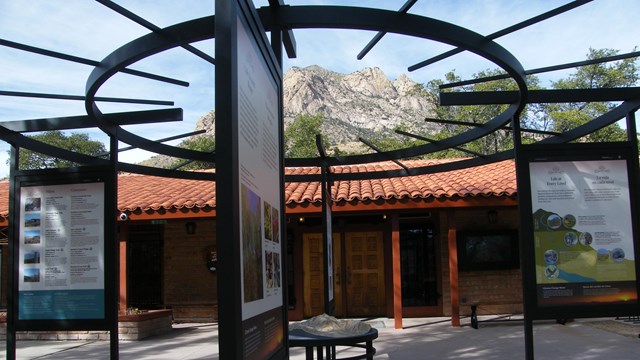 An outdoor exhibit with a tile-roofed building in the background