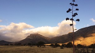 A cloud hangs on a mountain peak