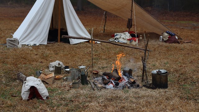 18th century camp site with an active fire
