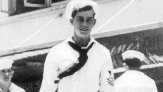 Historic photograph of a sailor in a white uniform