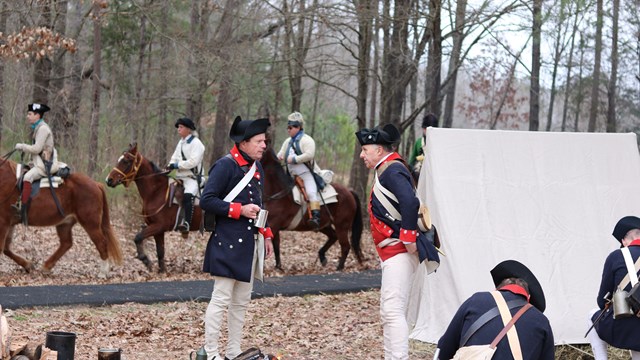 Two reenactors speaking in camp