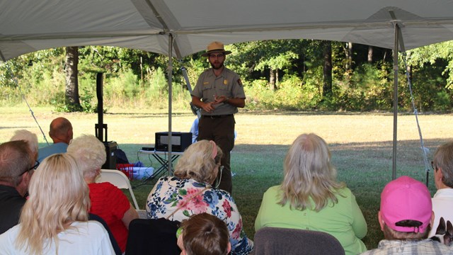 Ranger presents program in a tent. 