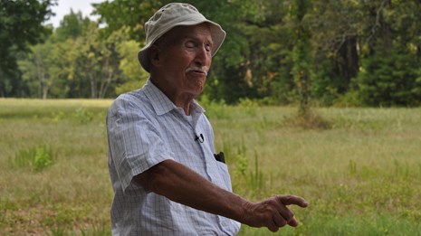 Ed Bearss points to a feature on the battlefield.
