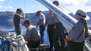 Part staff and researchers collecting water samples on a research boat.