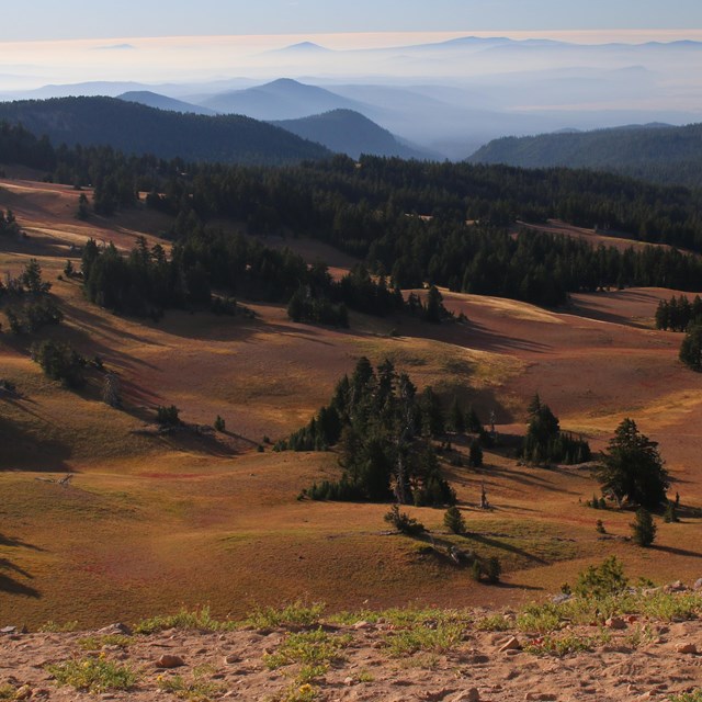 Red subalpine meadows expand across the landscape