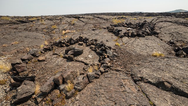 two circles of stacked rocks on a lava flow