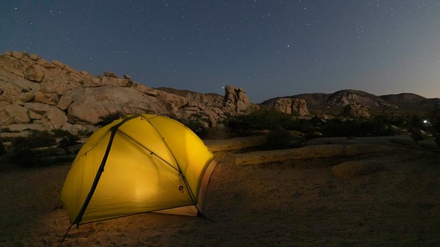 Tent in a desert with geological features