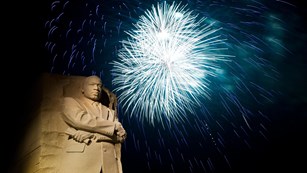 Fireworks go off in a display behind the Martin Luther King, Jr. Memorial at night