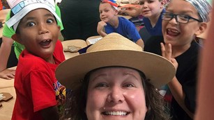 Ranger taking selfie with students in a classroom