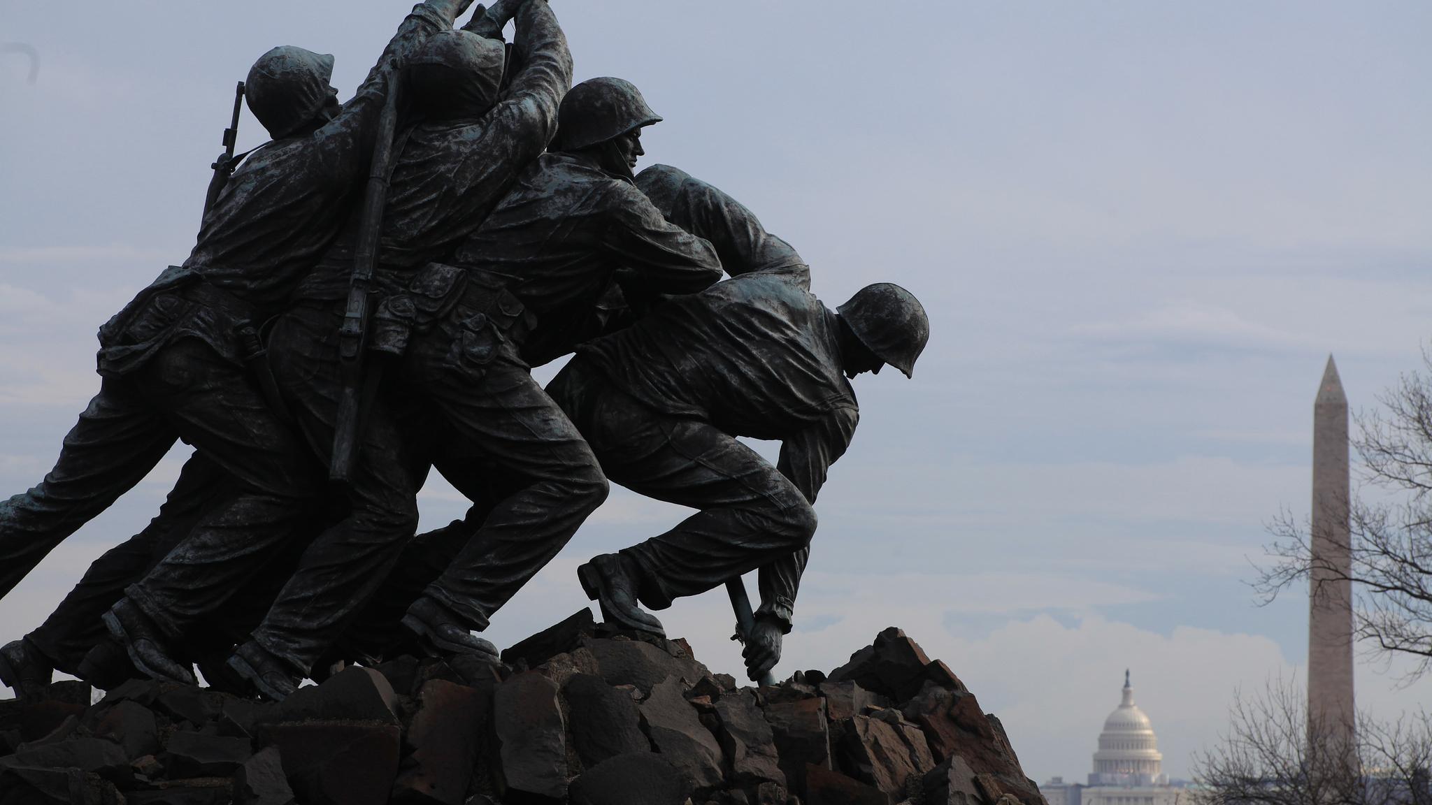 U.S. Marine Corps War Memorial statue with DC memorials in the distance