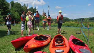 Kayak tour on land near their boats