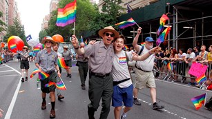 Park rangers and others march in a gay pride parade.