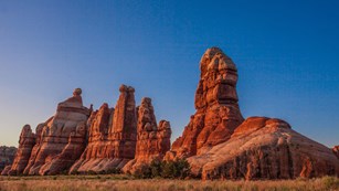 Rock spires glow orange in late afternoon light