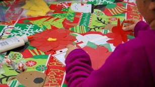 Person working on paper holiday crafts