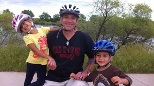 Dad with two kids on bikes