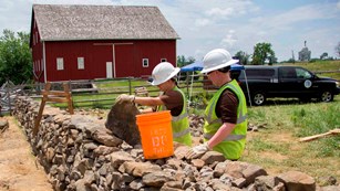 Ranges repairing a historic stone wall