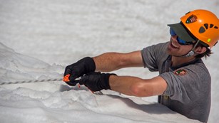 Ranger holding onto a rope in the snow