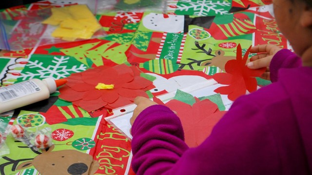 Girl cutting out holiday shapes