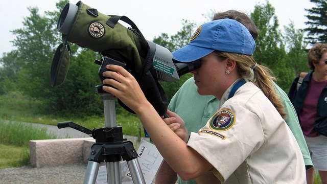 Volunteer looking through a telescope
