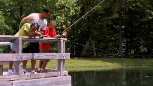 Family fishing on a dock