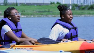 Two kayakers in life jackets