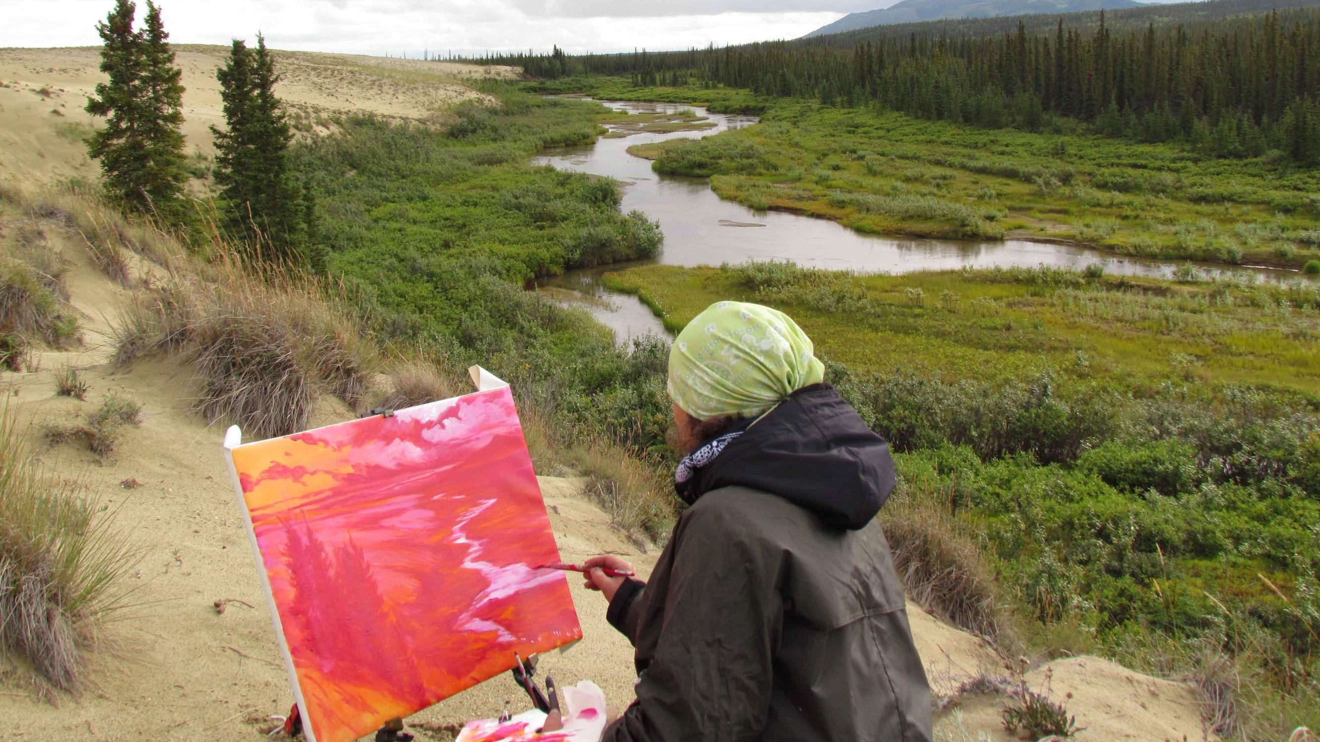 Woman painting a landscape