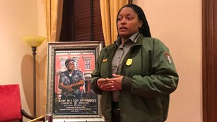 Ranger talking next to a painting of Mary McLeod Bethune