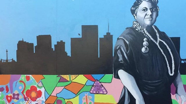 Mural of Maggie Walker against the Richmond city skyline