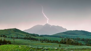 Lightning over a mountain and valley