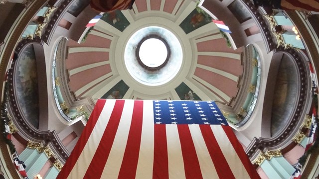U.S. flag hanging from a domed ceiling