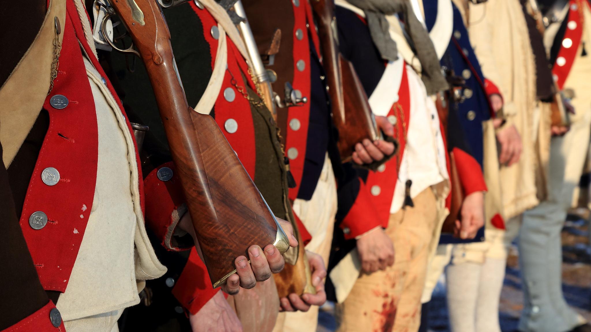 Line of Continental Army reenactors holding their muskets