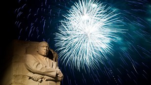 Firework over a statue of Dr. Martin Luther King Jr.
