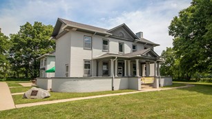 Two-story white house on a big lawn