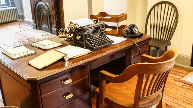 Desk with a typewriter and papers