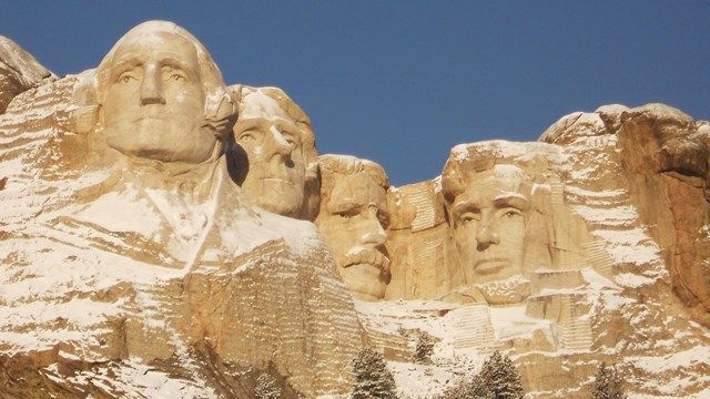 Mount Rushmore including sculptures of presidents Washington, Jefferson, Roosevelt, and Lincoln