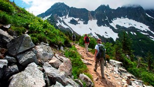 Several hikers on a mountain trail