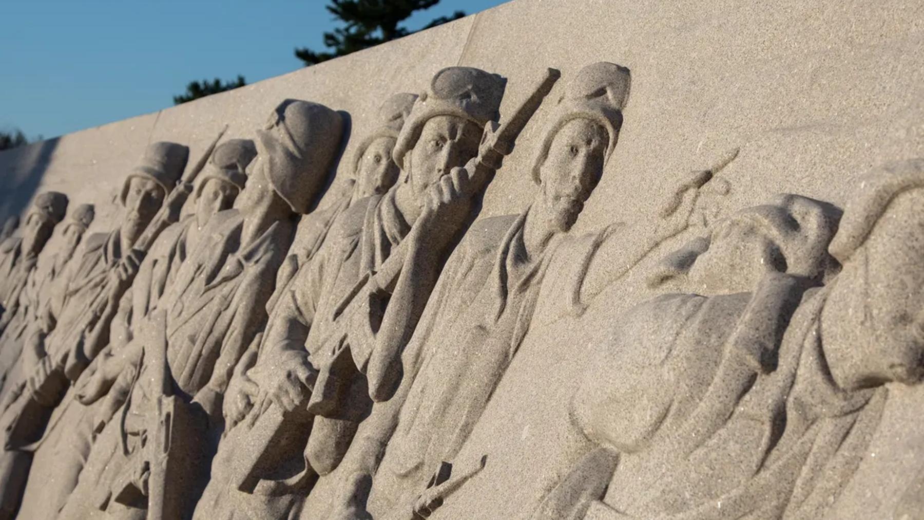 Memorial wall with a relief of U.S. soldiers in Desert Storm & Desert Sheld marching 