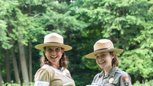 Ranger in older women's uniform next to a modern-dressed ranger