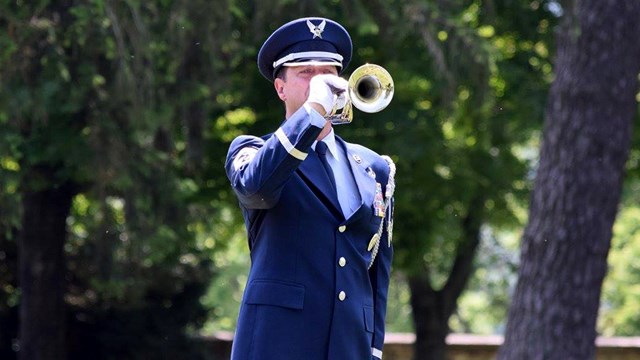 Military officer playing a bugle