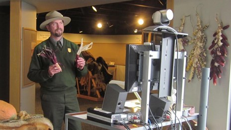 Ranger holding props in front of a computer camera