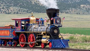 Steam engine train on a railroad track