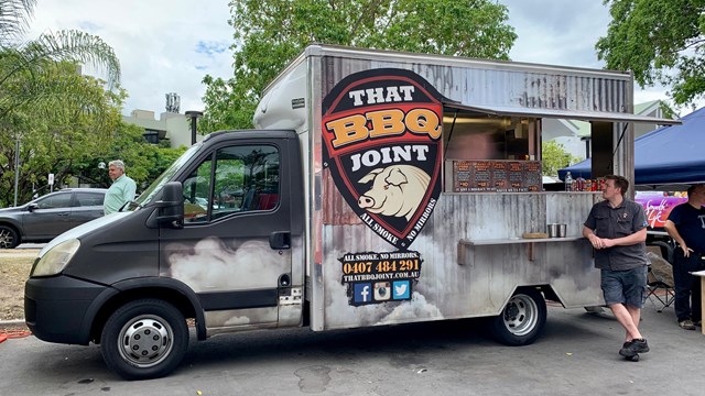 A food truck parked on the side of the road