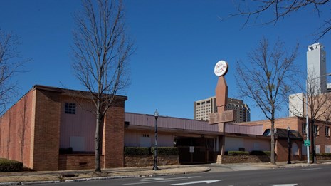 A.G. Gaston Motel in Birmingham in 2010, a low building with flat facade, stone planters, and sign