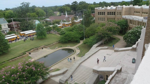 Little Rock Central High School landscape with entry staircase, reflecting pool, lawn and trees.