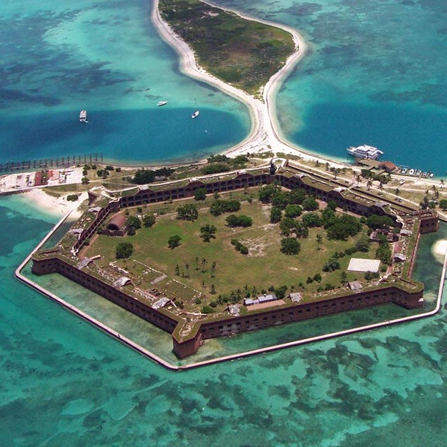 From overhead, Fort Jefferson at Dry Tortugas National Park is surrounded by bright blue water.