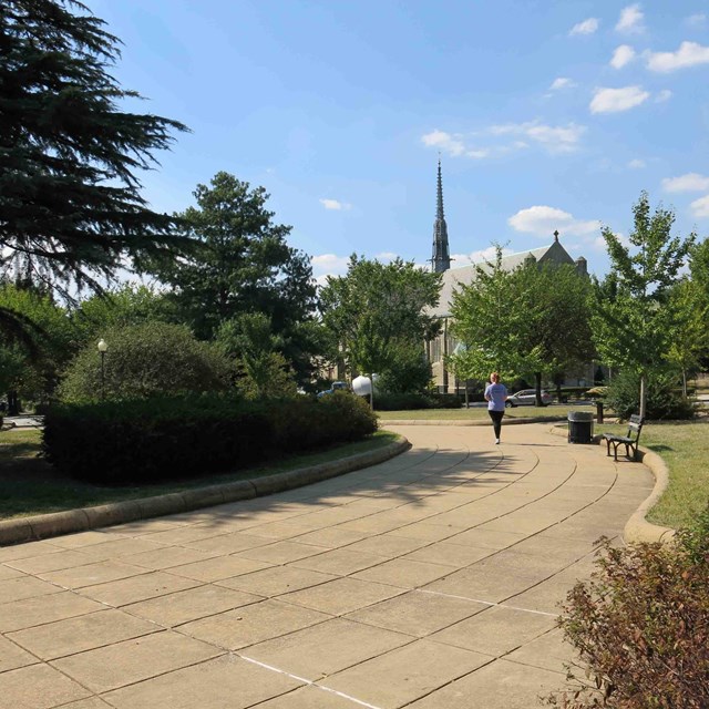 Jogger follows a gently curving paved pathway at Grant Circle